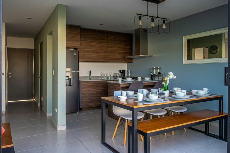 a kitchen with a table and a bench in it